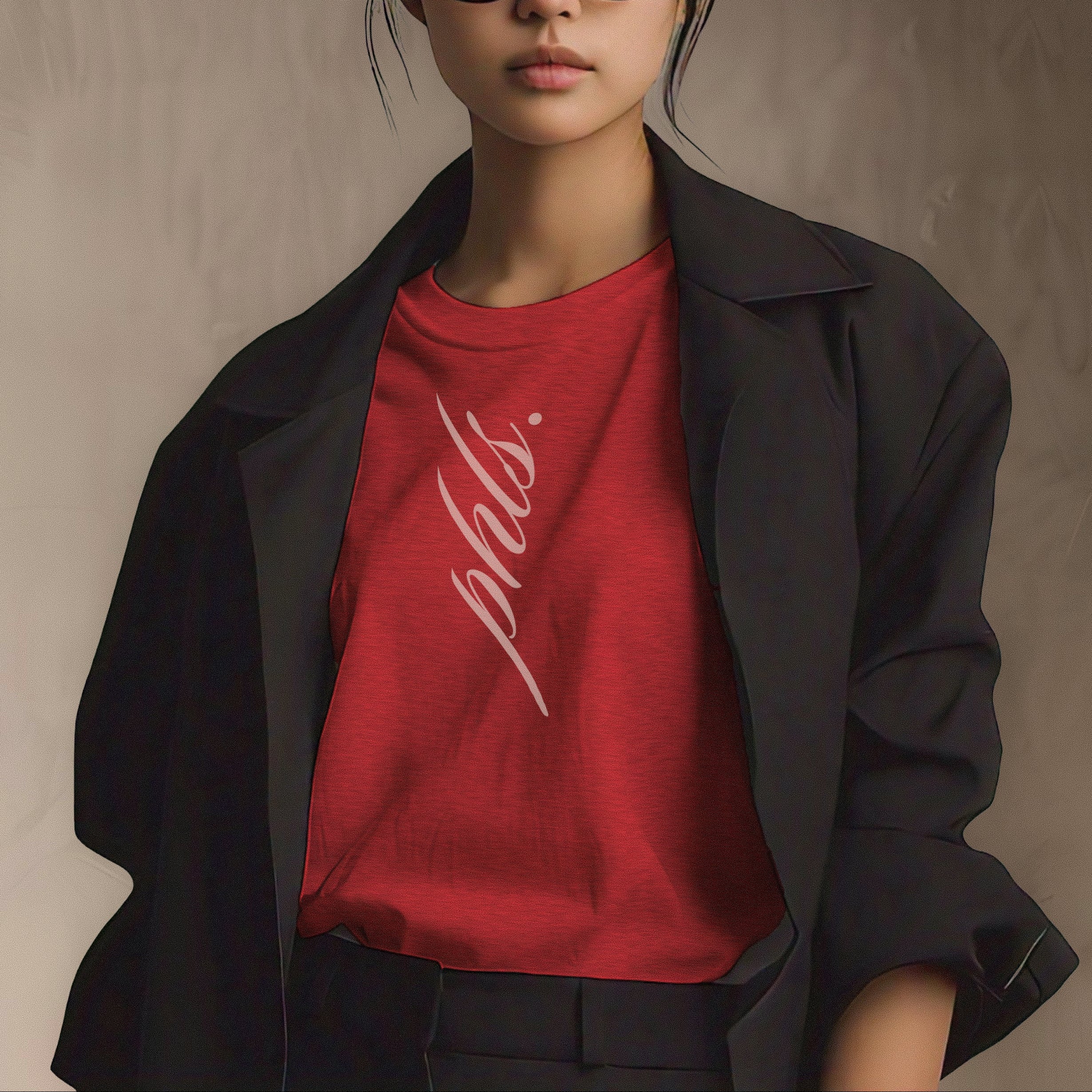 Person wearing a red shirt with text and a black jacket against a neutral background