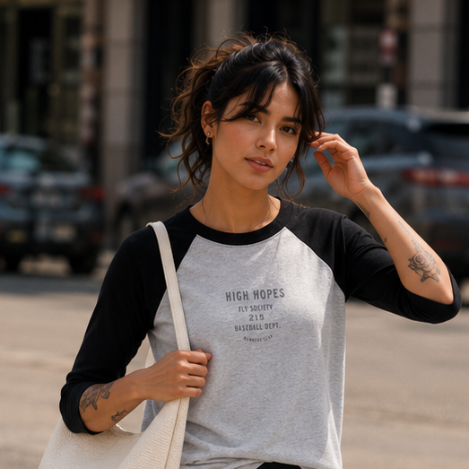 Woman crossing a street wearing a casual outfit with a tote bag.