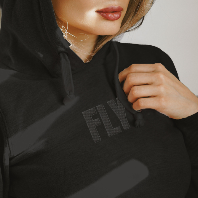 Black hoodie with 'FLY' embroidery on a neutral background