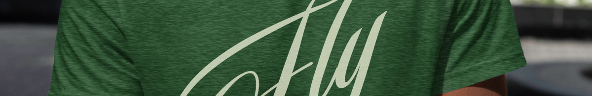 Person wearing a green t-shirt with 'Fly' printed on it, standing outdoors.