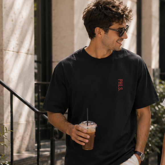 Two people walking on a sidewalk in an urban setting
